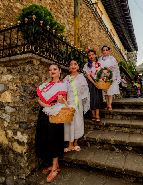 Free Women in traditional Mexican attire on stone stairs, Huauchinango, Mexico. Stock Photo