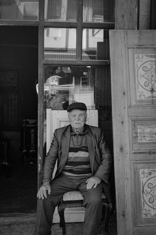 A man sitting in front of a door