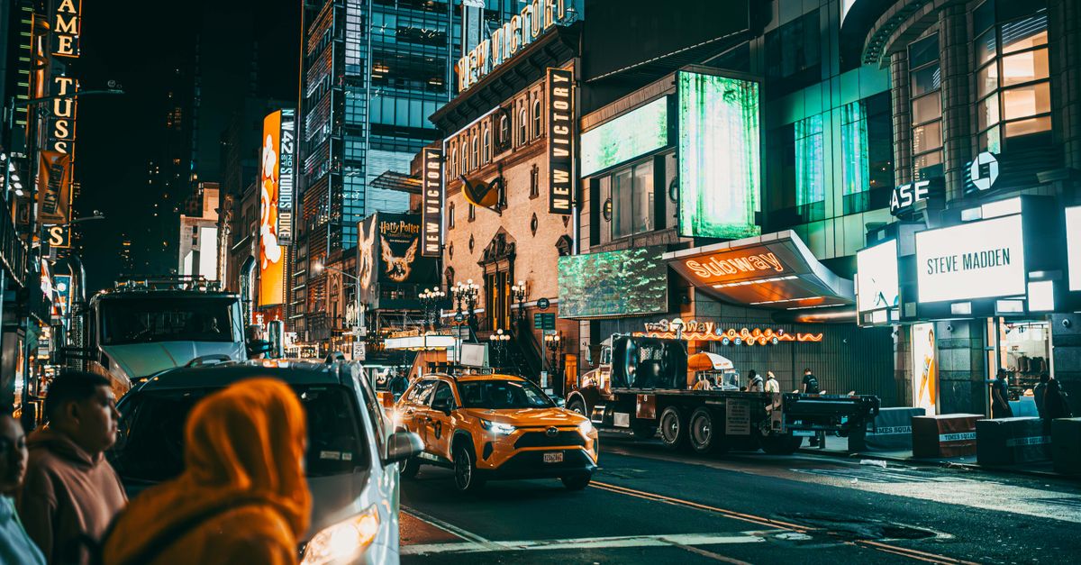 Steve Lacy's 'Oh yeah?' Projected for 34K Billboard 200 Debut as Nat Luna Releases New Single 'DIVA' Bustling Times Square street scene at night with bright lights and taxis in New York City.