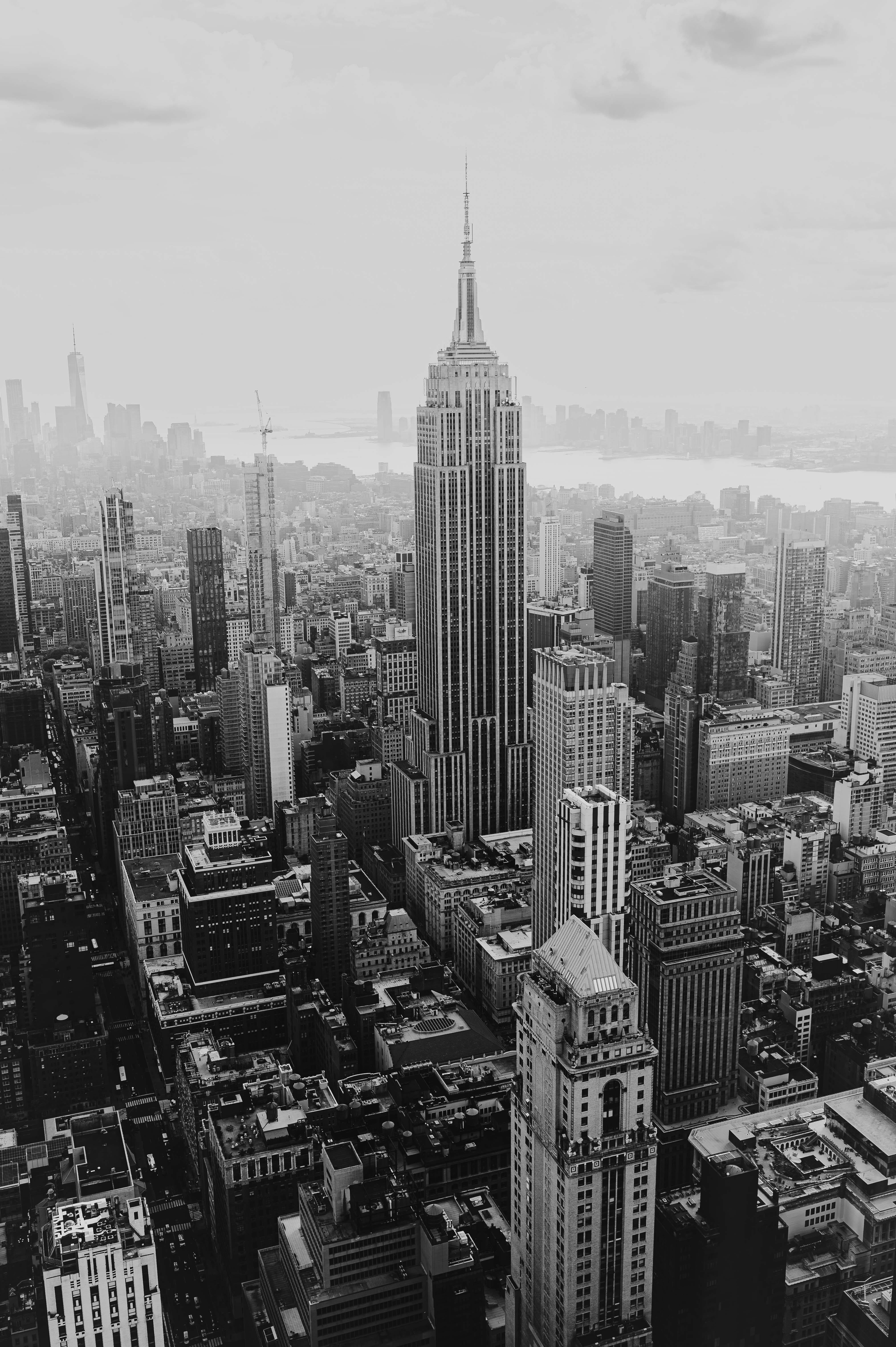 Aerial black and white view of New York City skyline featuring the Empire State Building.