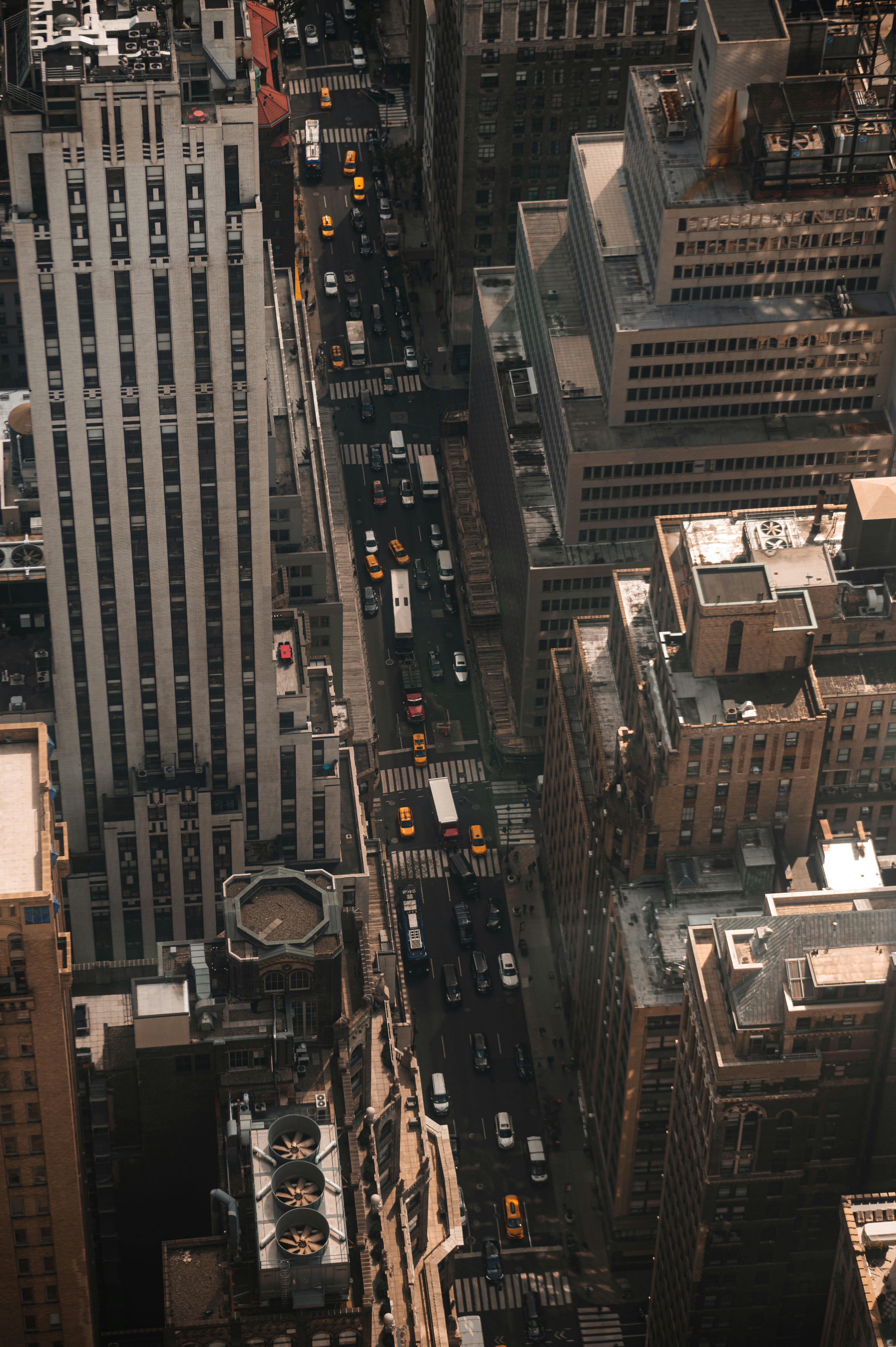 A bustling aerial view of New York City streets with skyscrapers and yellow taxis.