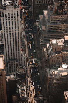 A bustling aerial view of New York City streets with skyscrapers and yellow taxis.