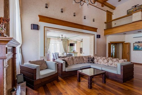 Free Luxurious living room featuring a large sectional sofa and elegant decor. Stock Photo