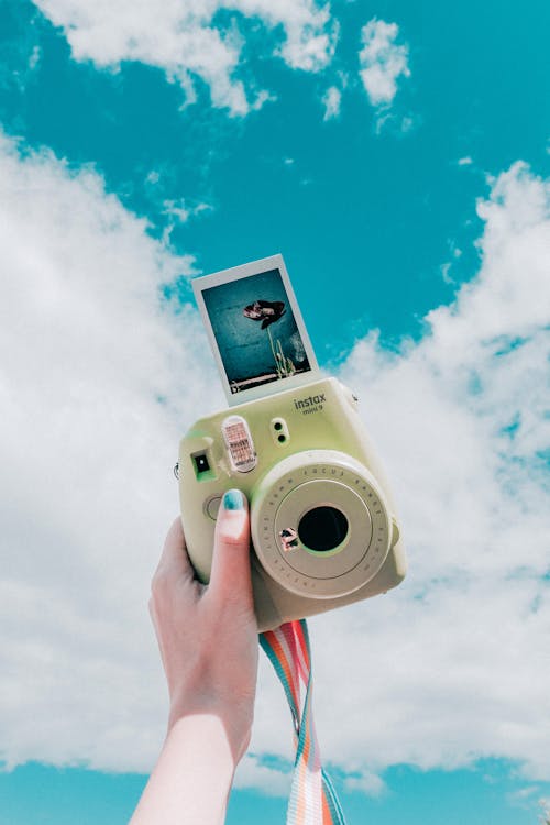 Person Holding Instant Camera With Photo · Free Stock Photo