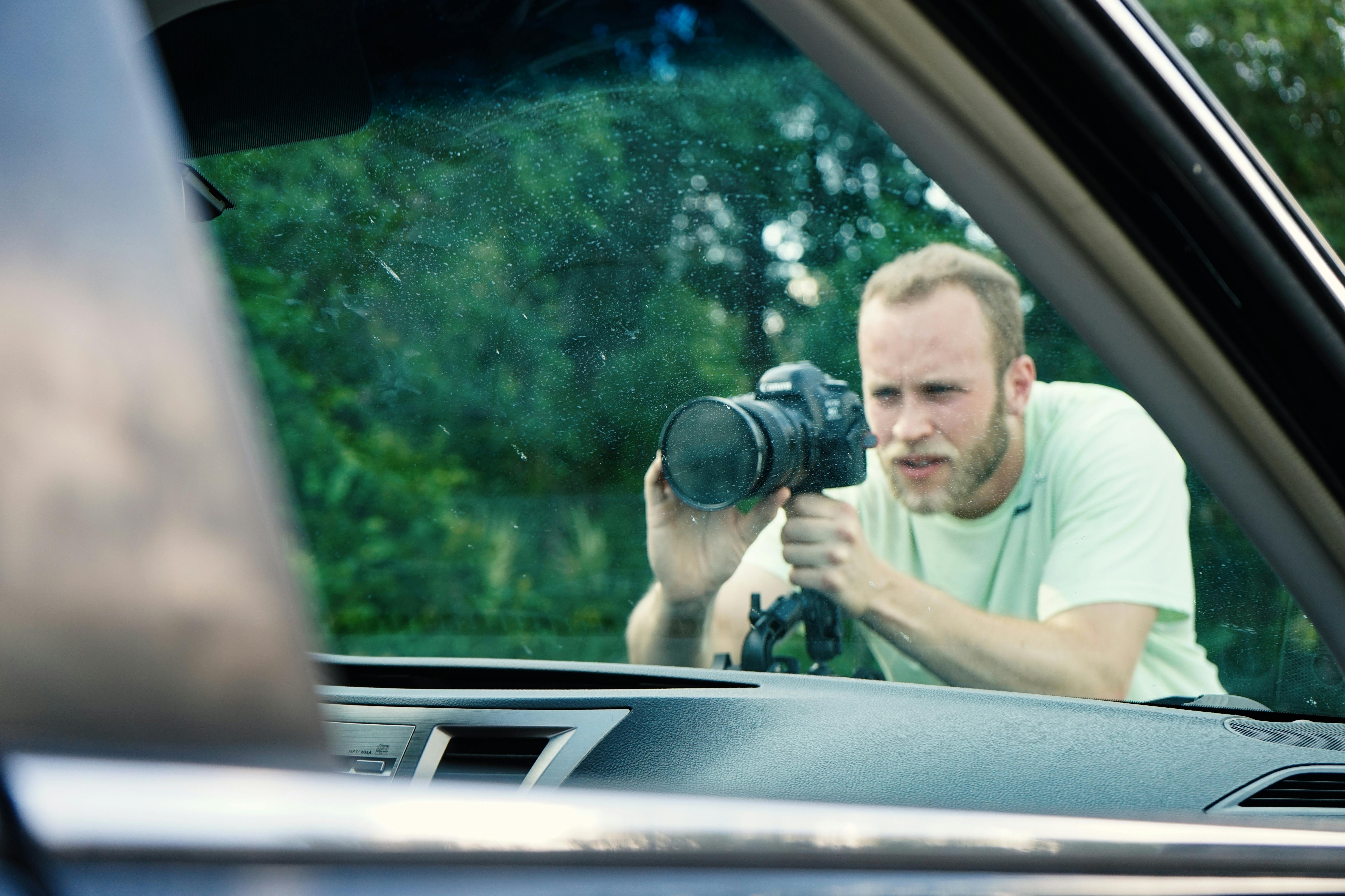 man taking photo near vehicle