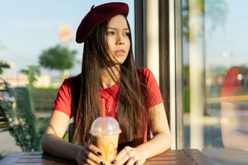 Free Woman Wearing Red Crew-neck T-shirt and Red Flat Cap Stock Photo
