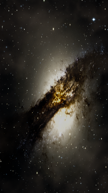 A stunning view of a galaxy with bright stars and a dark central dust lane in space.