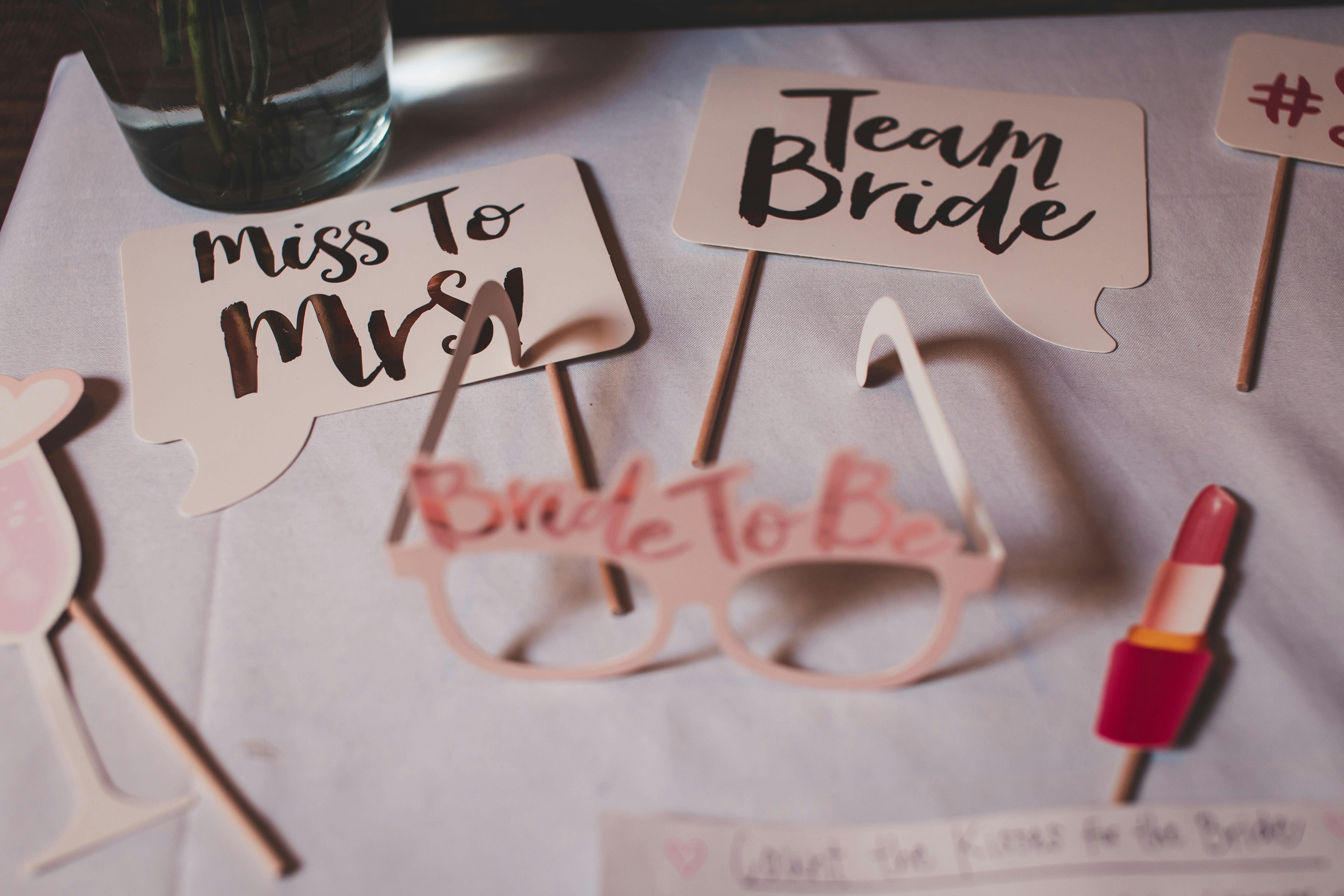 Flat lay of bridal shower decorations with creative signs and props.
