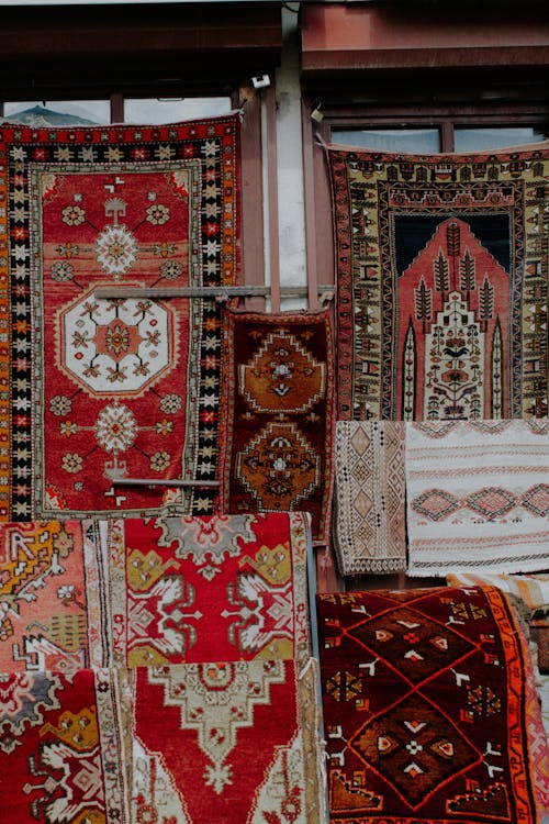A variety of rugs are displayed in a shop