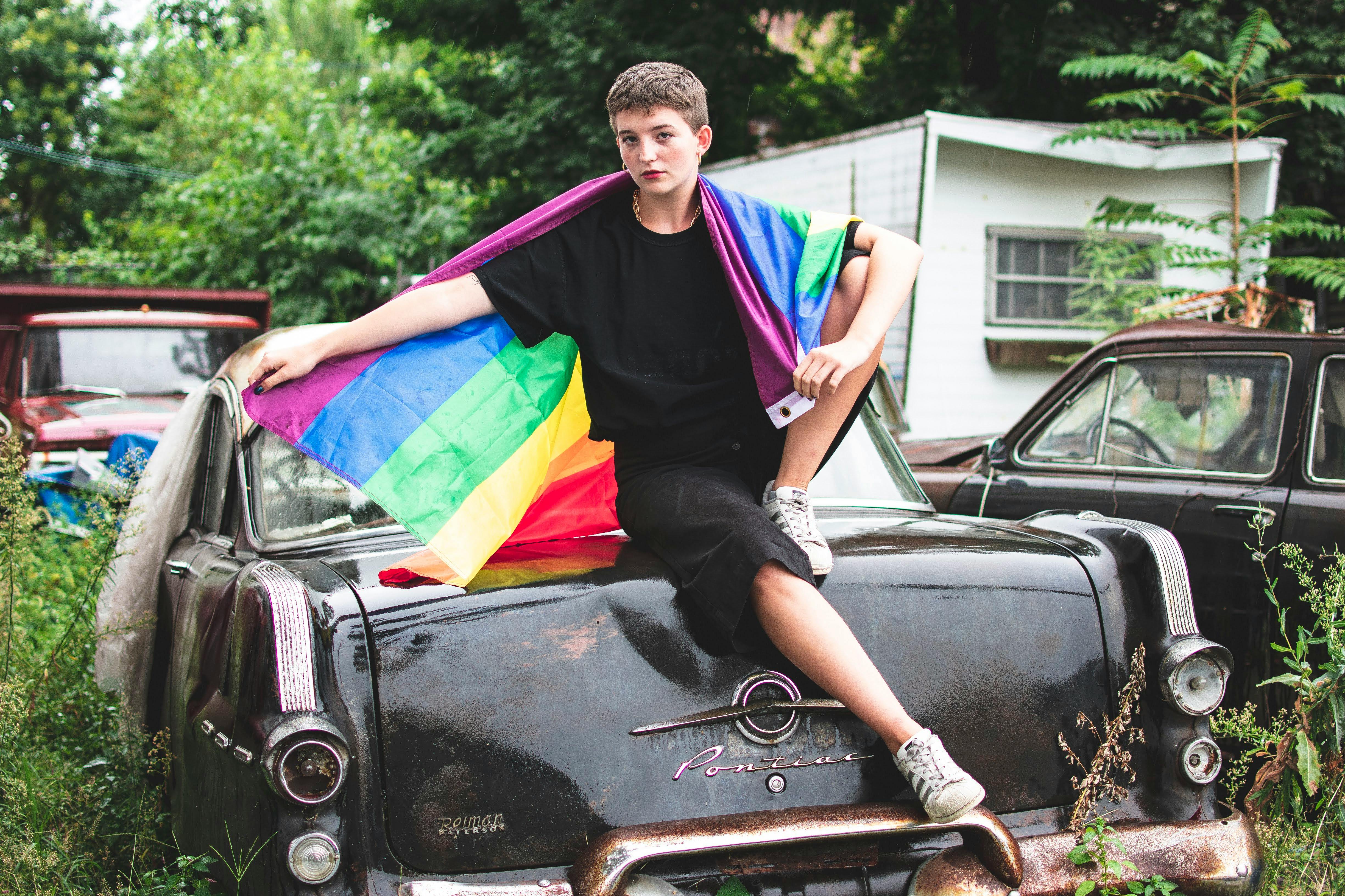 Person Wearing Black Crew-neck T-shirt Sitting on Vehicle