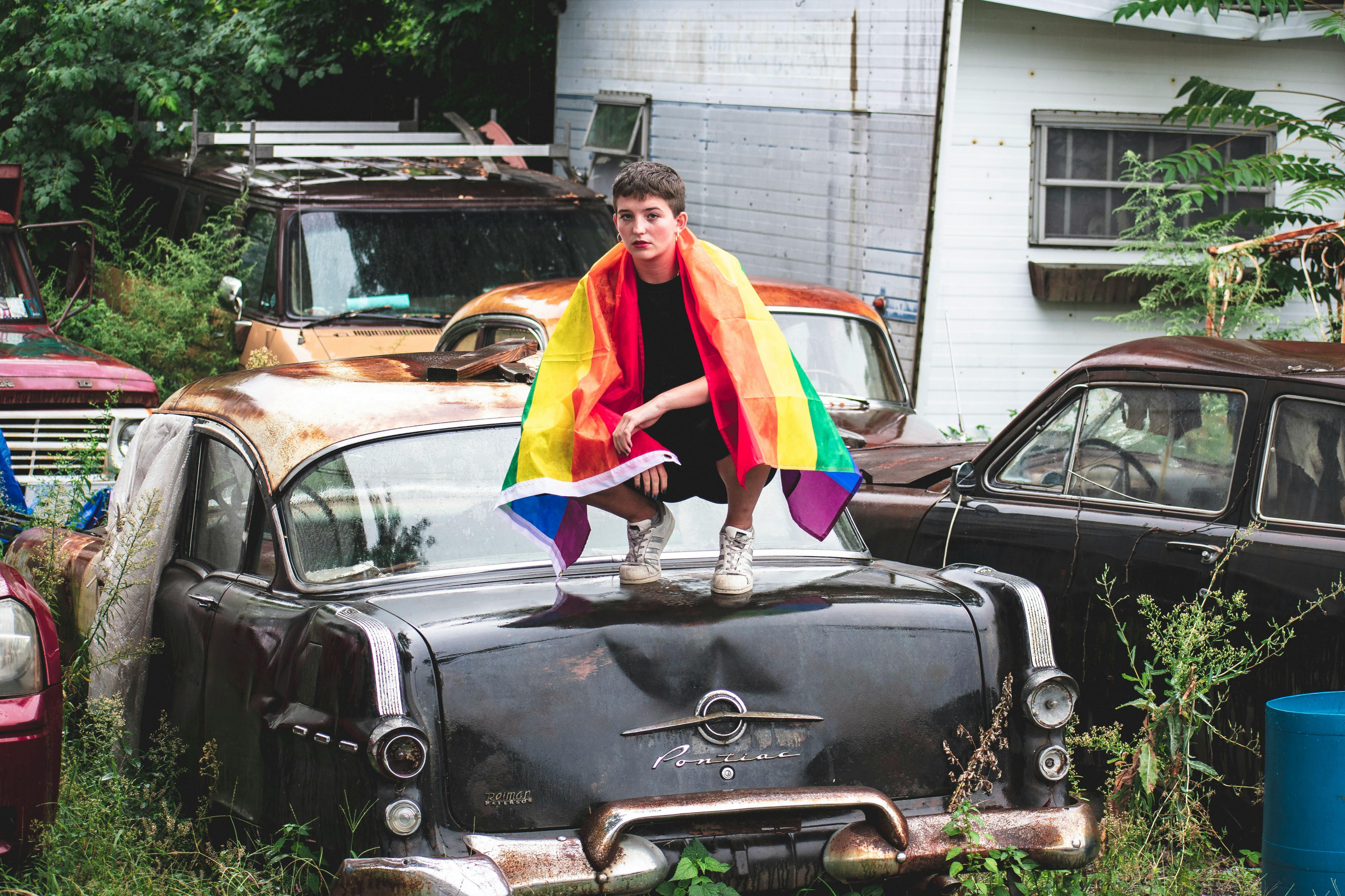 Person Sitting on Vehicle Hood