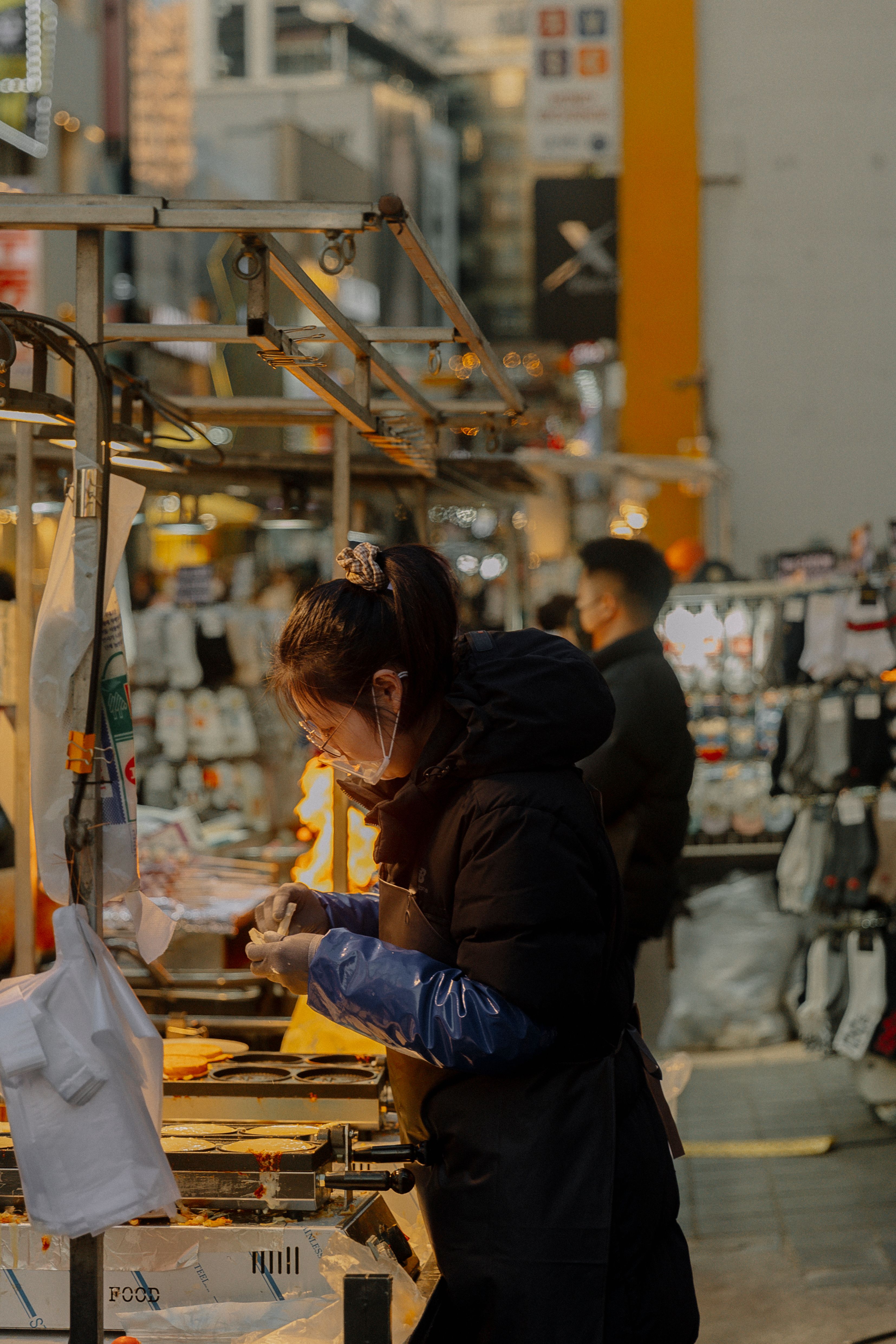 Side View of a Woman Selling Food at a Market · Free Stock Photo