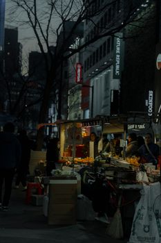 Explore the lively street food stalls of Seoul's bustling night market scene.