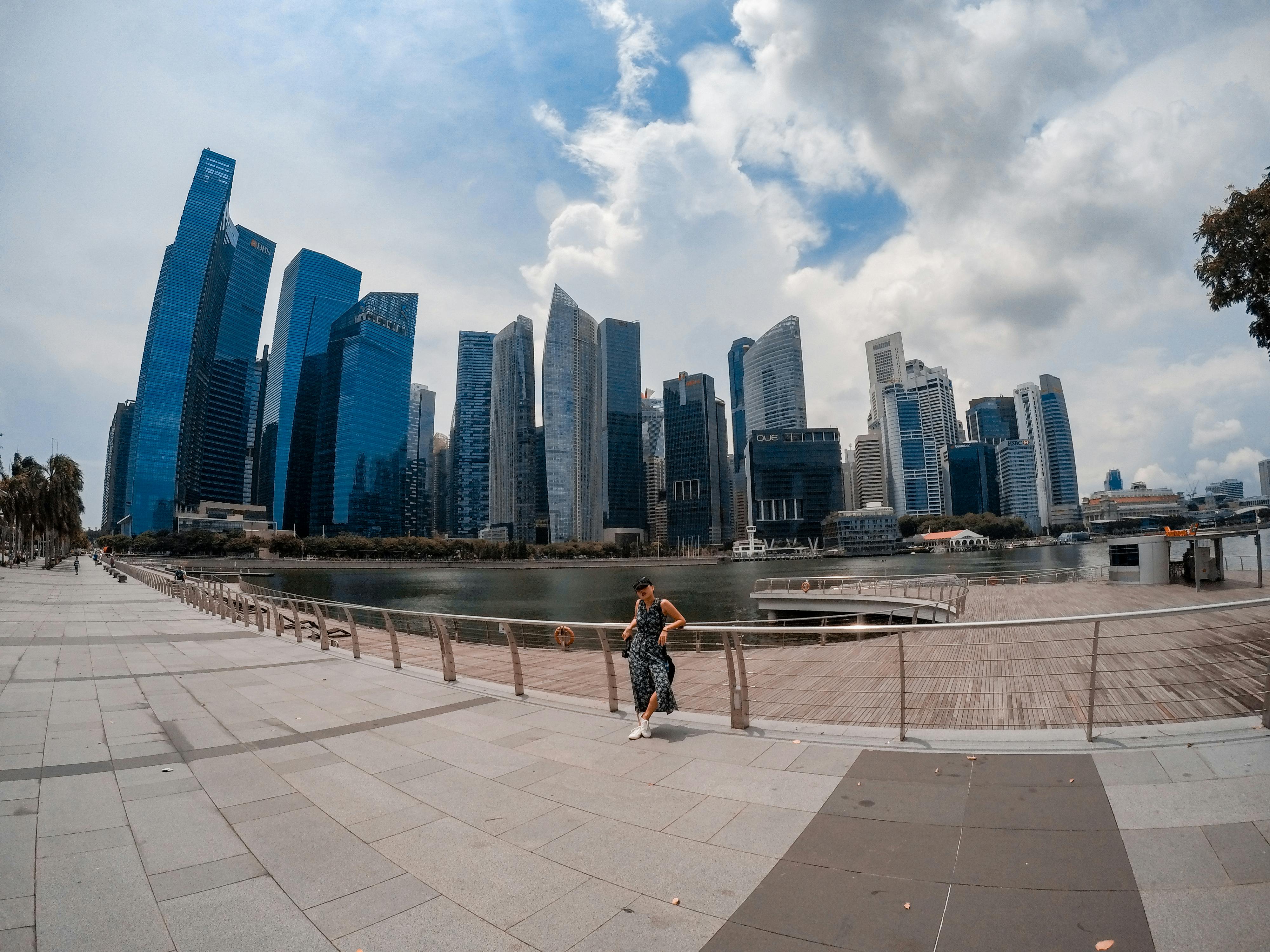 person standing near high rise buildings