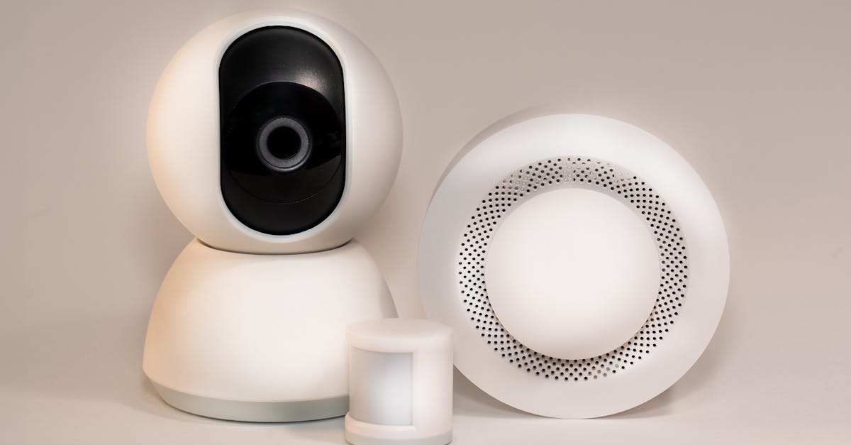 Smart home security devices including a security camera, motion sensor, and alarm system, showcasing modern technology for enhanced home safety.