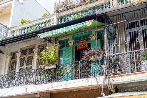 Free A vibrant balcony with potted plants and ornamental railings in Ho Chi Minh City. Stock Photo