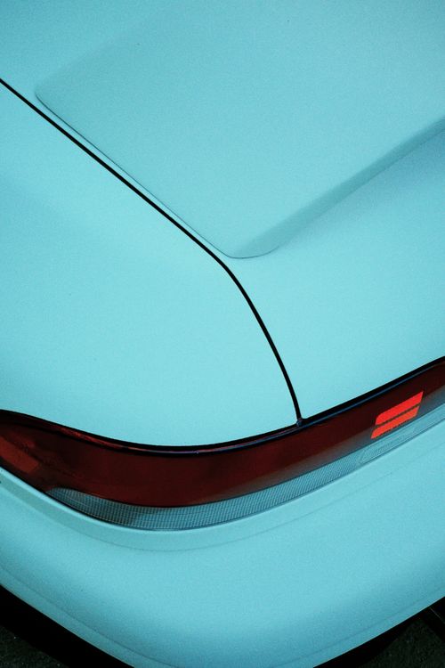 Free Detail shot of a blue car's rear with highlighted red brake light Stock Photo