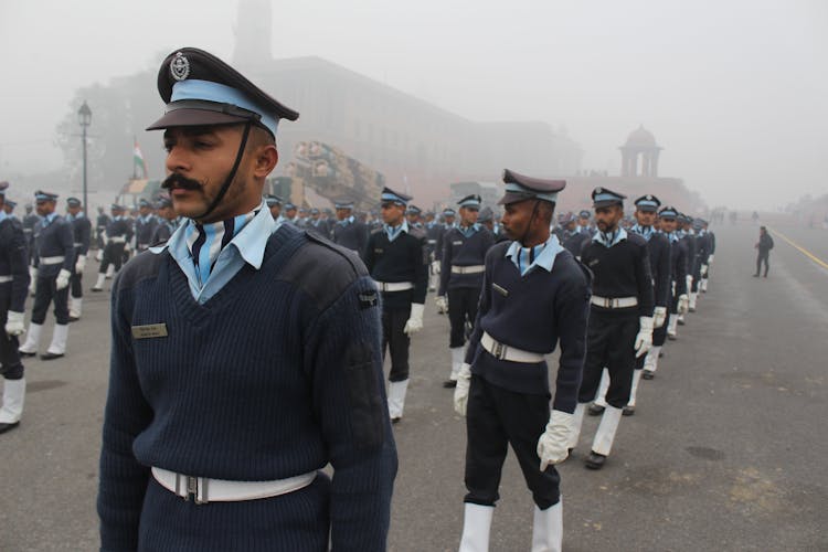 Group Of Military Men Wearing Uniform In The Street