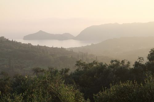 Free Breathtaking view of Corfu's misty landscape and sea islands at sunset. Stock Photo