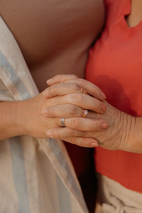 Free Intimate close-up of two women holding hands, symbolizing connection and support. Stock Photo