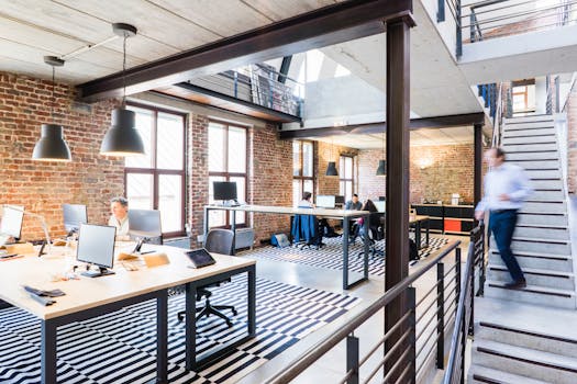 Spacious and stylish open-plan office with loft and industrial aesthetic.
