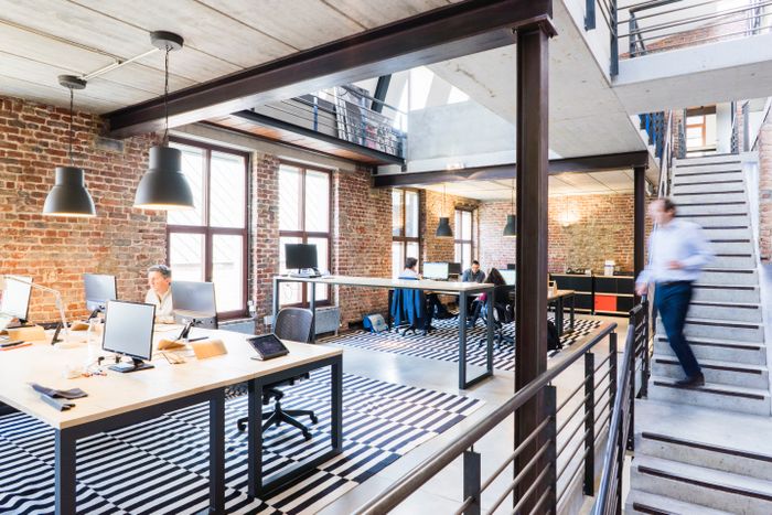 Brick-and-steel loft office on two levels — photo by Proxyclick Visitor Management System on Pexels