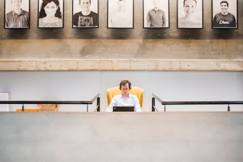 Person Sitting on Yellow Chair