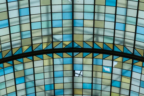 A stained glass ceiling with blue and yellow designs