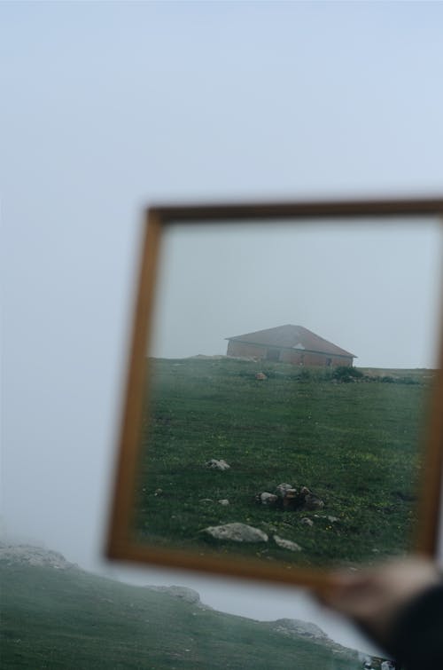 Blurred Reflection of a Brown House on a Framed Mirror