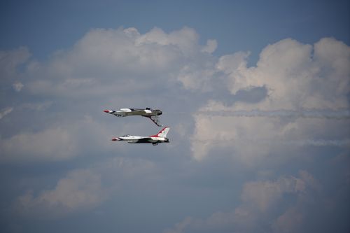 Free Two jets perform impressive aerial maneuvers against a vibrant blue sky in Charleston, SC. Stock Photo