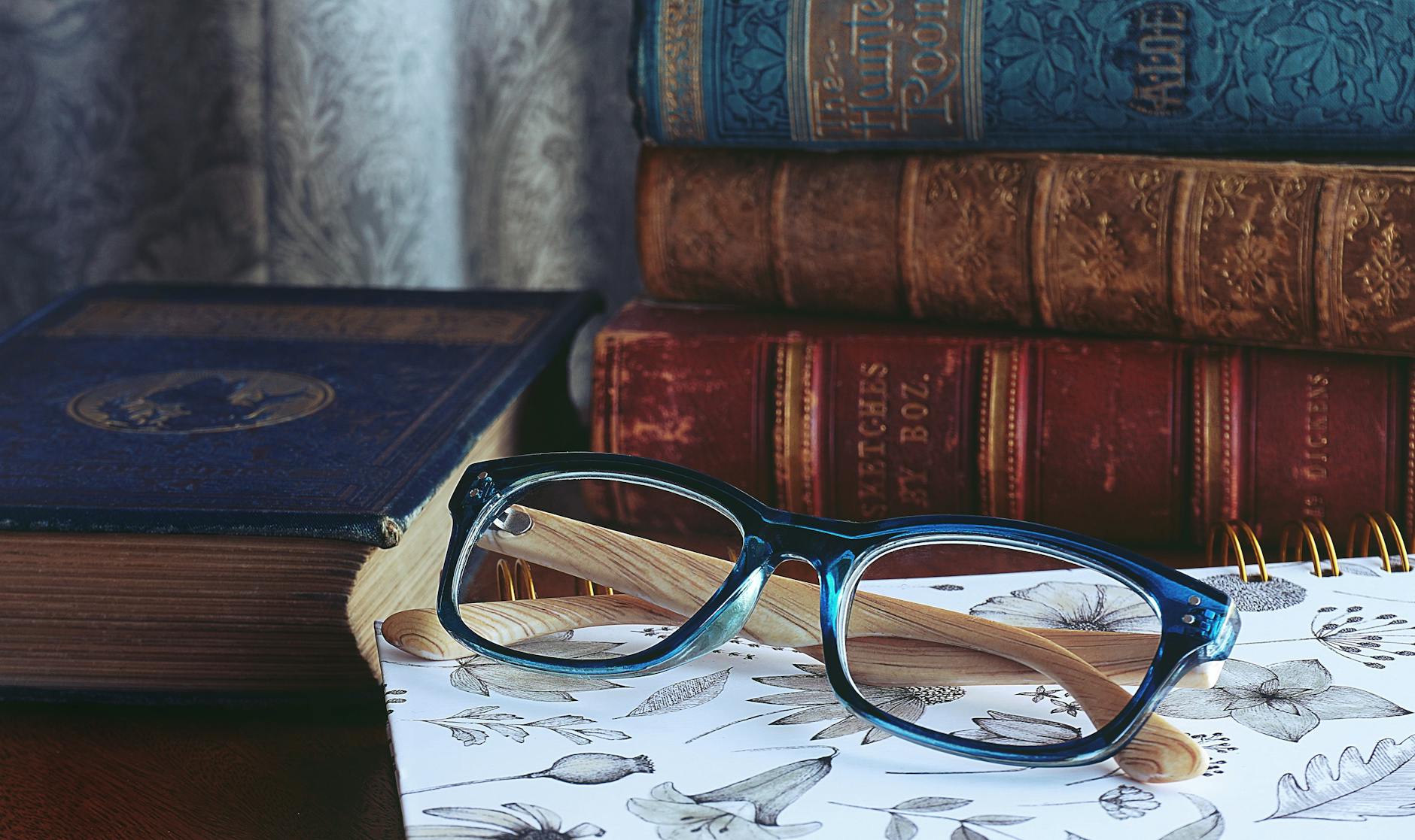 EnChroma Glasses beside a couple of books at the table