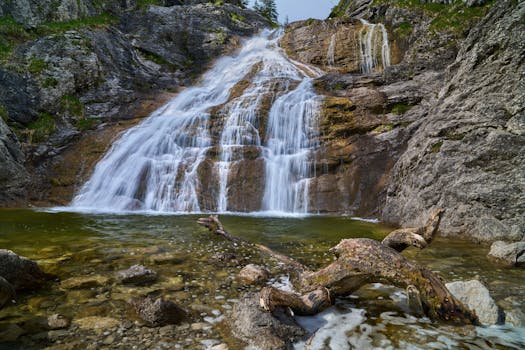 Explore the tranquil beauty of a waterfall cascading over rocky terrain in Jachenau, Bavaria.