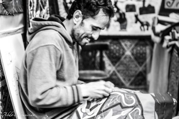 Neatly organized skate boots on shelves in an indoor shop setting, ready for sale.