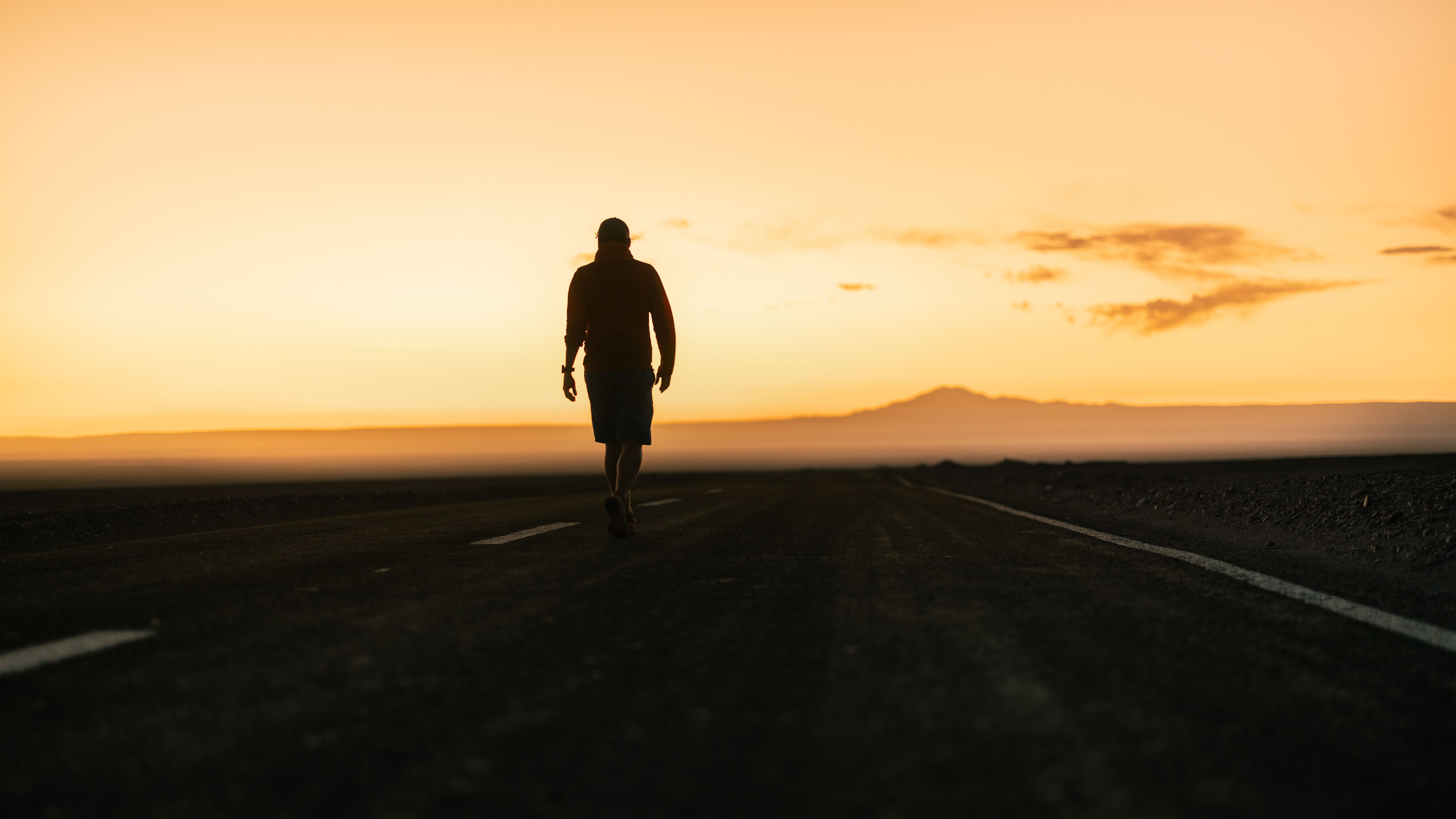 Man Walking on Road under Yellow Sky at Sunset · Free Stock Photo