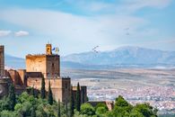View of Alhambra fortress with an air show over Granada, Spain.