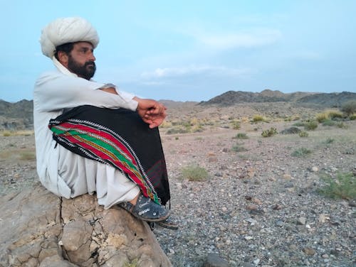 balochi culture dress with dastar background mountain sky 