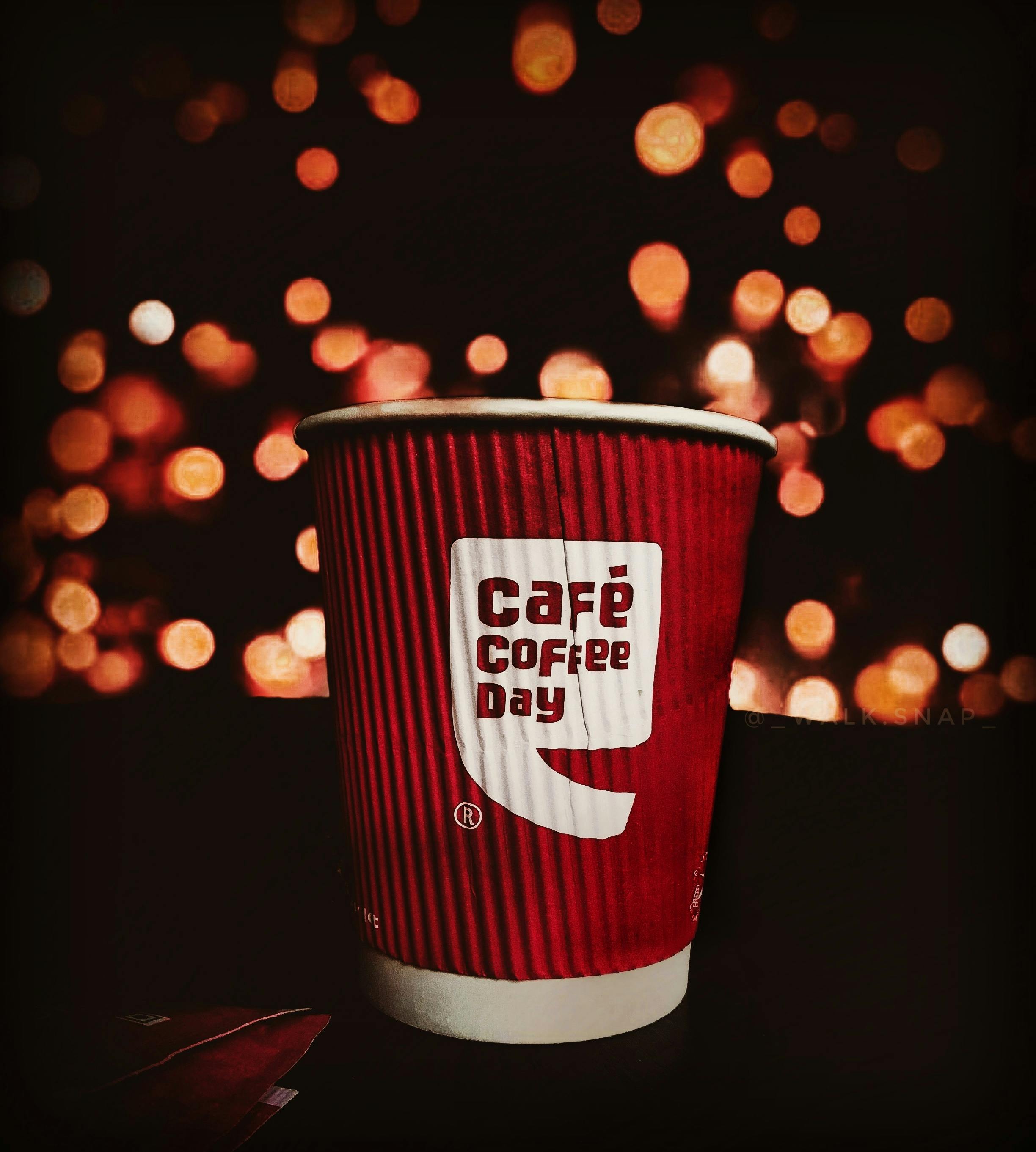 Selective Focus Photo of Red and white Cafe Coffee Day Disposable Paper