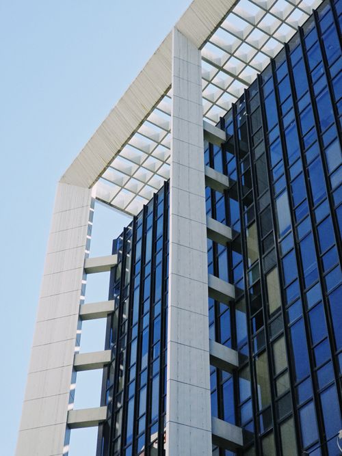Free Close-up of a contemporary skyscraper with striking glass and steel architecture. Stock Photo