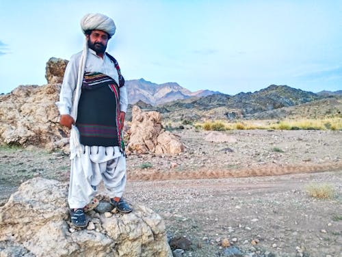 balochi culture dress with dastar background mountain sky 