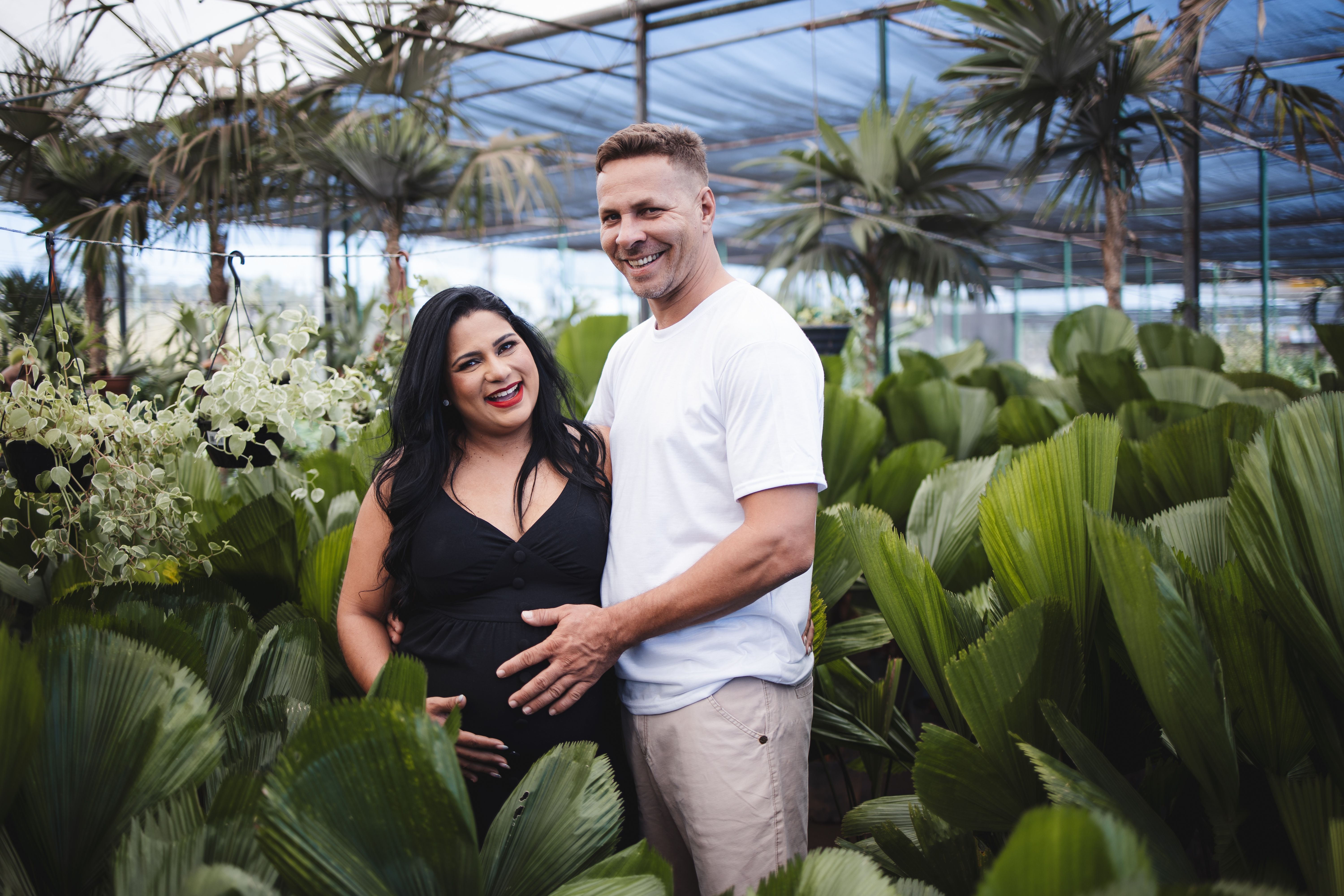 Happy Couple of Expecting Parents Standing in a Gardening Store · Free ...