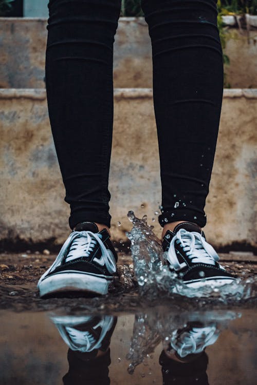 Free Person Stepping on Body of Water Stock Photo