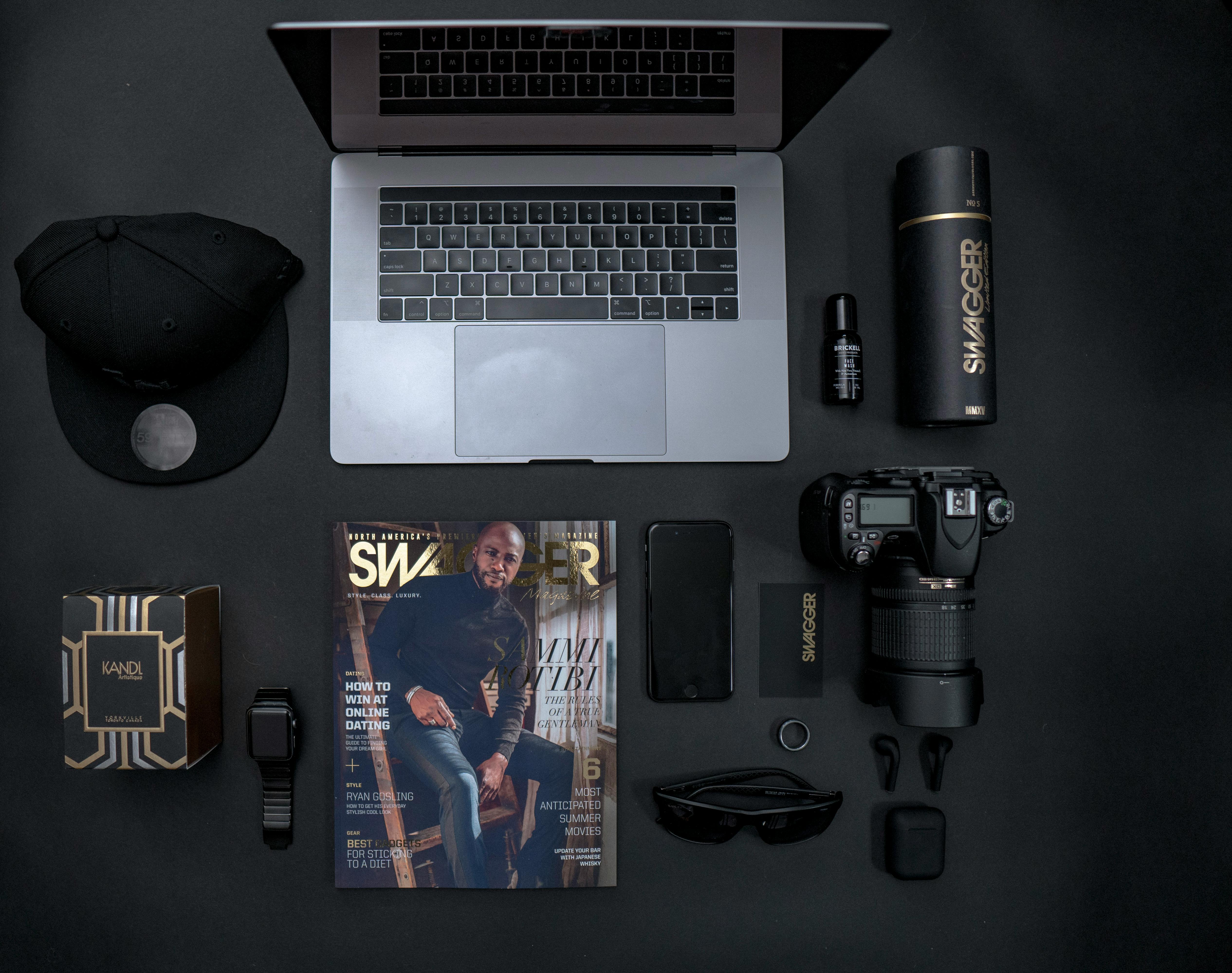 flatlay photography of laptop beside dslr camera