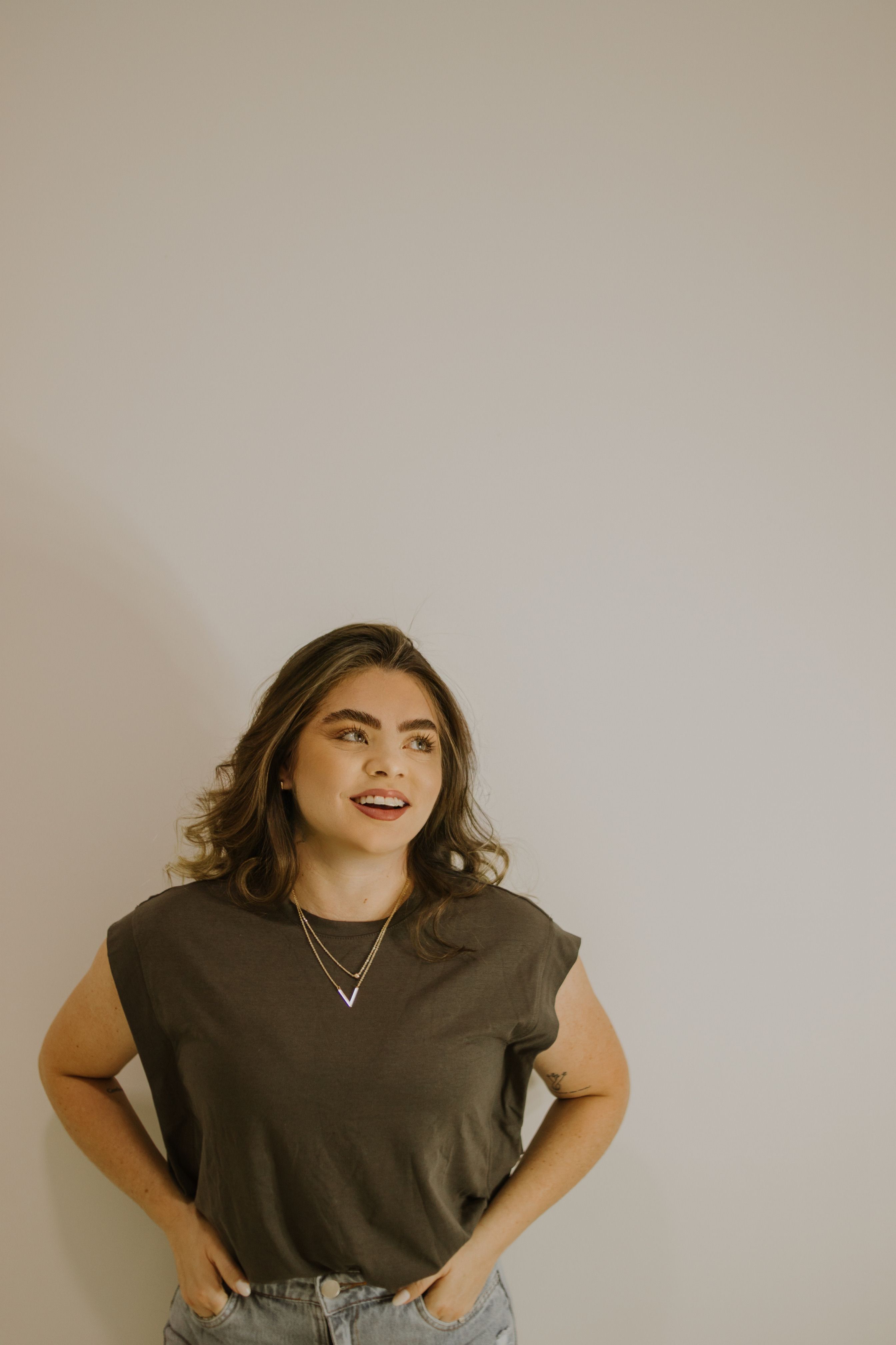 Portrait of a brunette woman in casual attire with ample copy space, ideal for fashion photography.