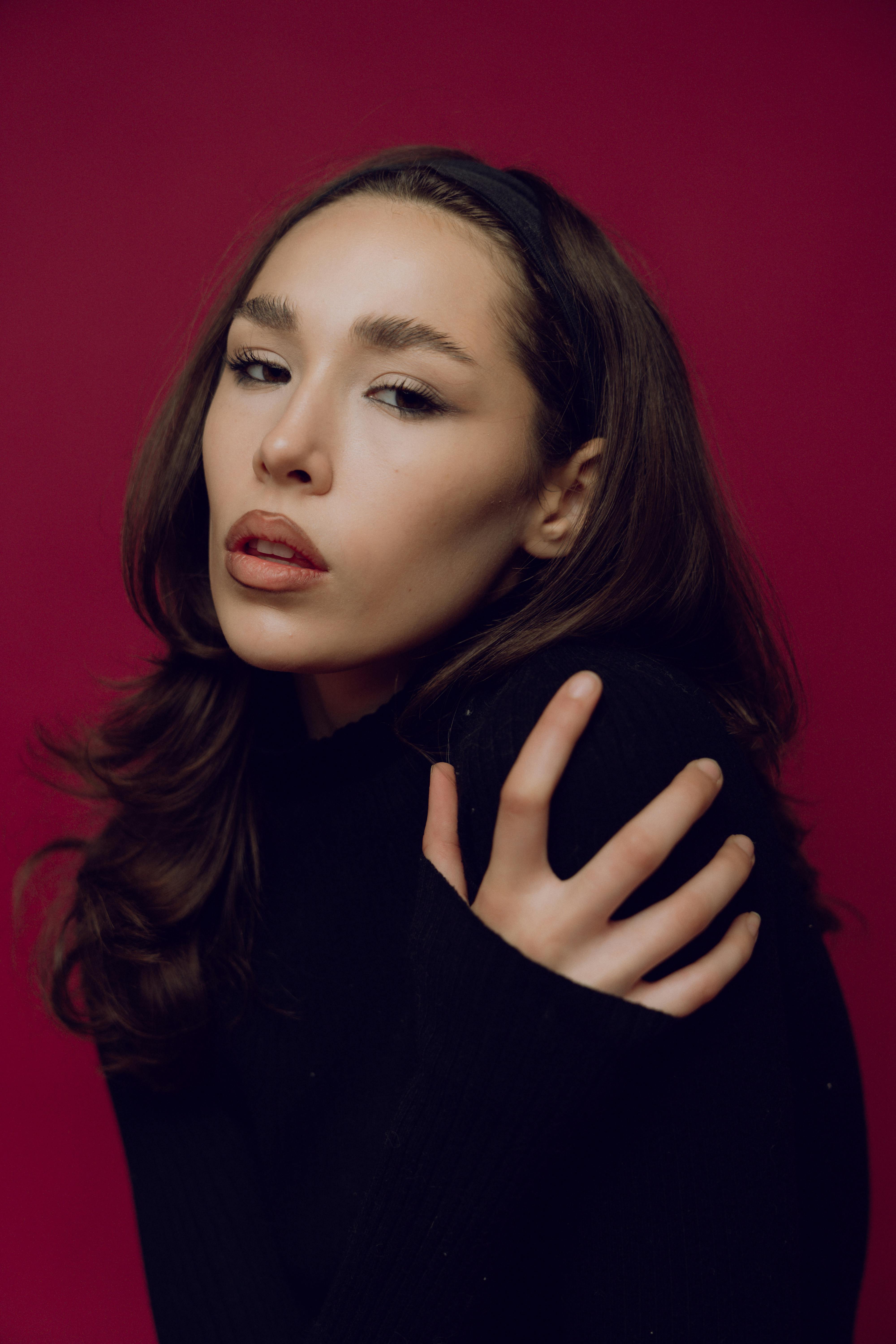 a woman with long hair posing for a portrait