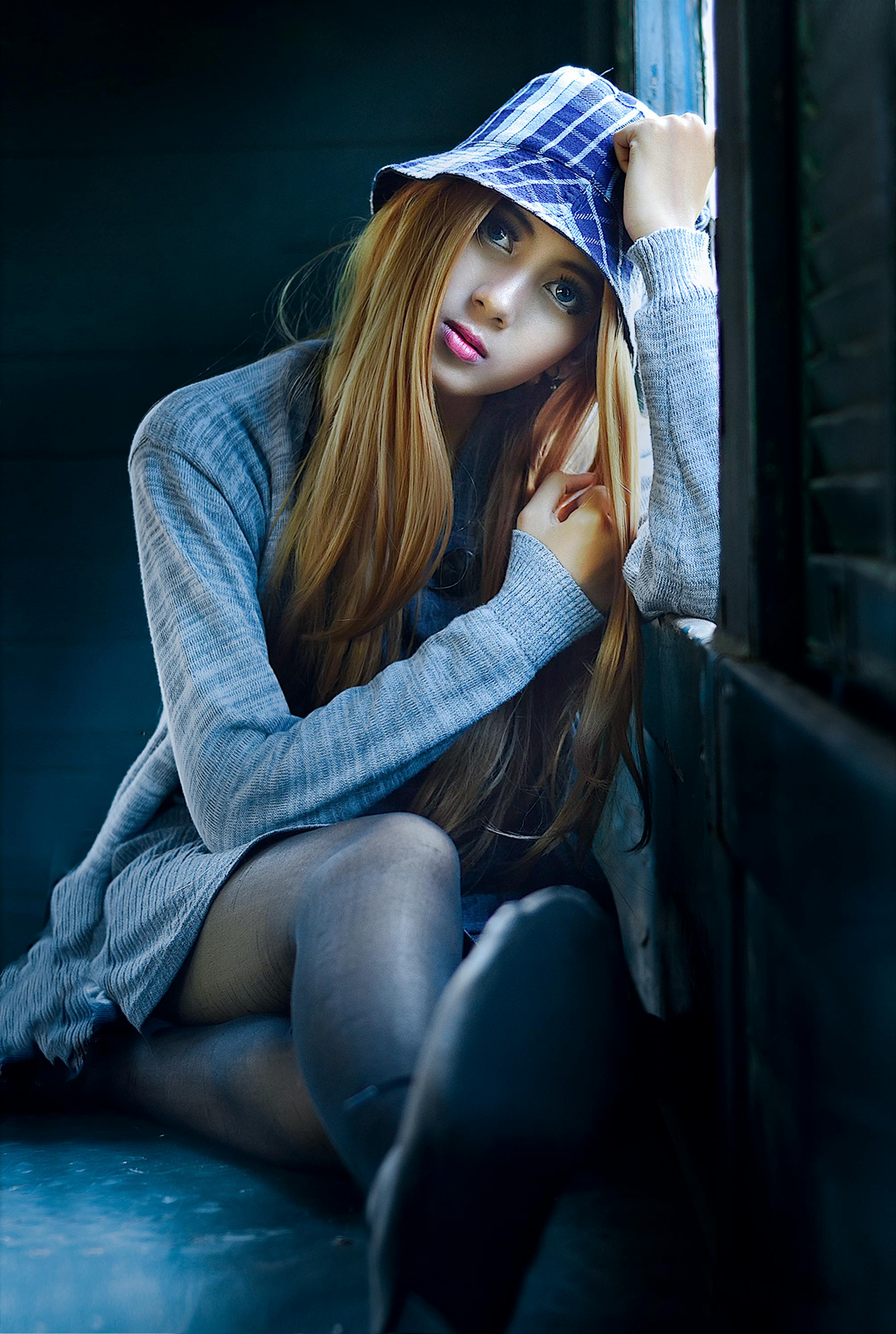 woman wearing heather gray cardigan leaning on window