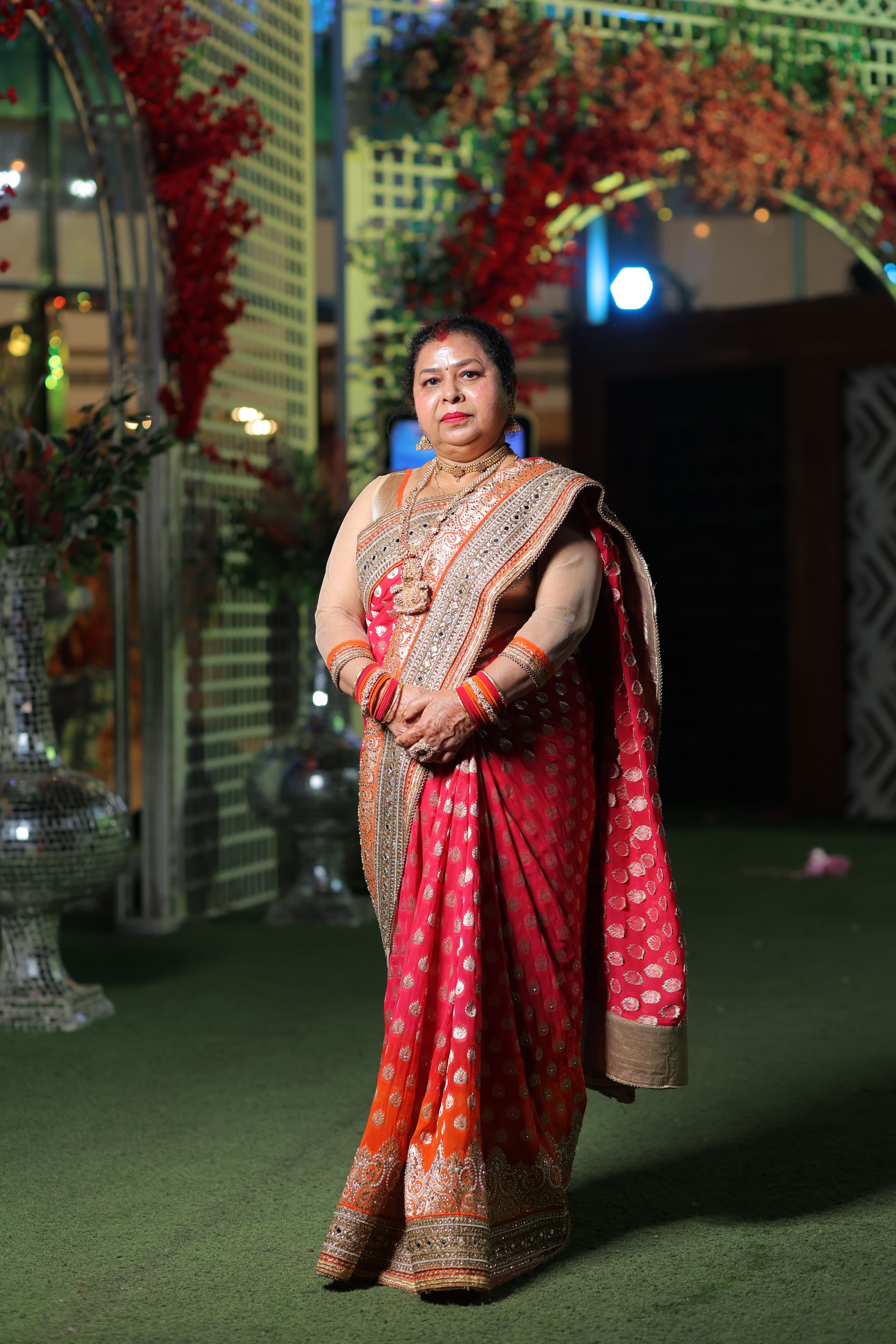 A woman in a red sari posing for the camera · Free Stock Photo