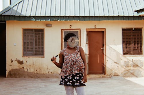 Woman Standing Near House