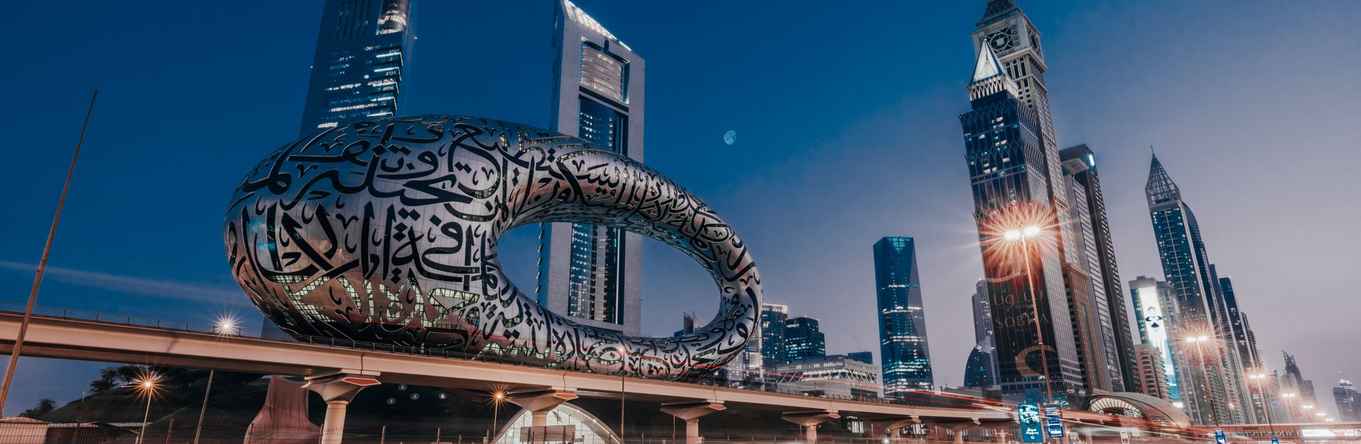Dynamic view of the Museum of the Future in Dubai, showcasing modern architecture with city light tr