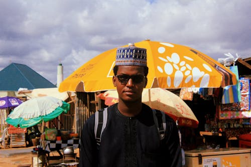 Man Near Parasols And Umbrellas