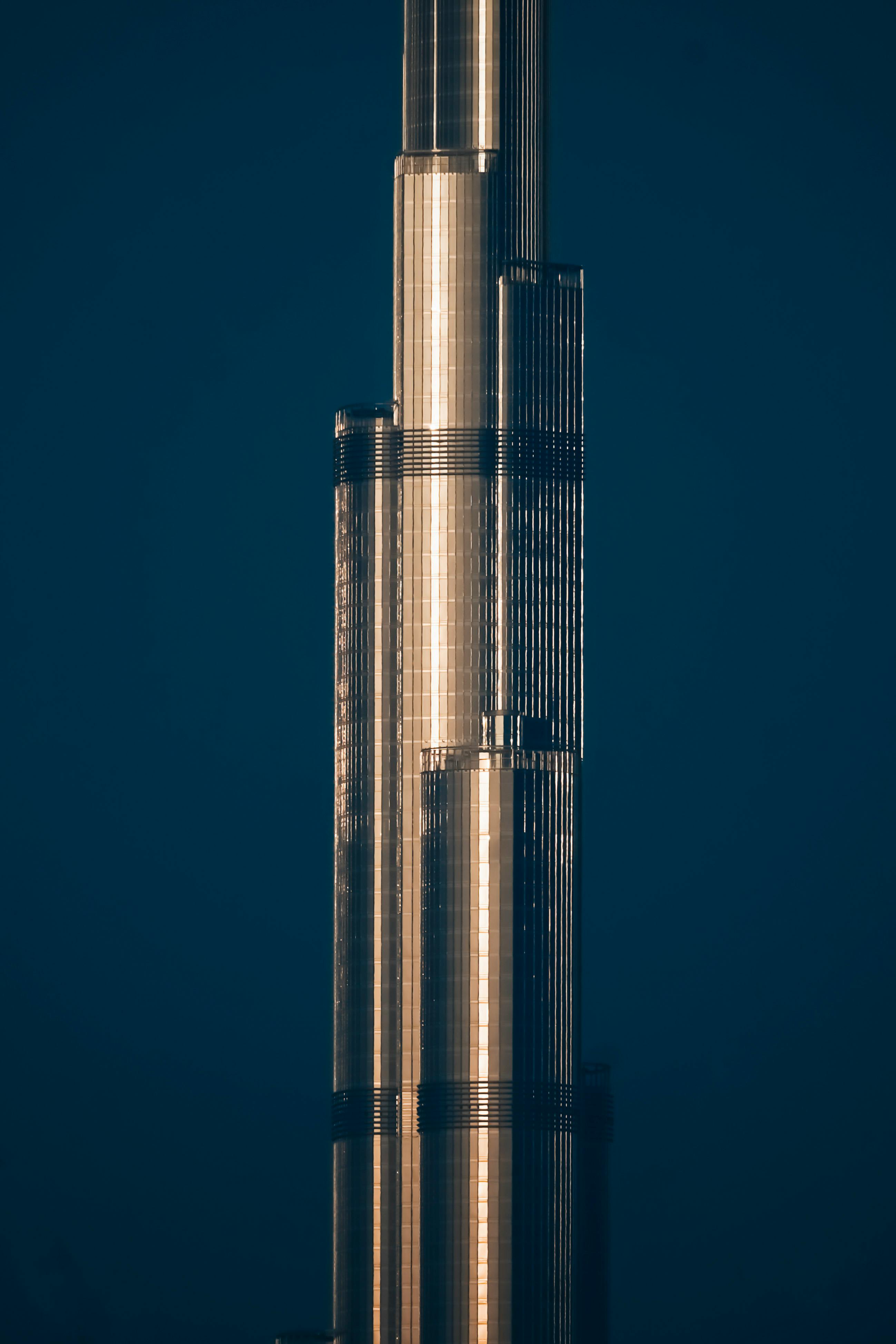 Close-up of the Burj Khalifa illuminated against the night sky in Dubai, showcasing its architectural elegance.